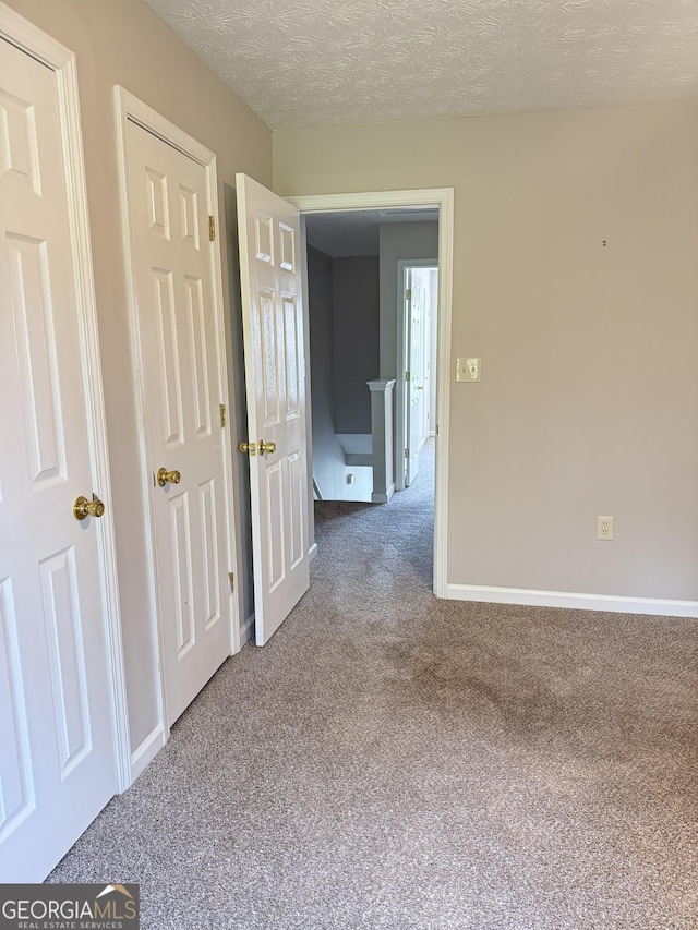 6433 Wellington Chase Ct, Lithonia, GA 30058 - empty room with carpet flooring, a textured ceiling, and baseboards