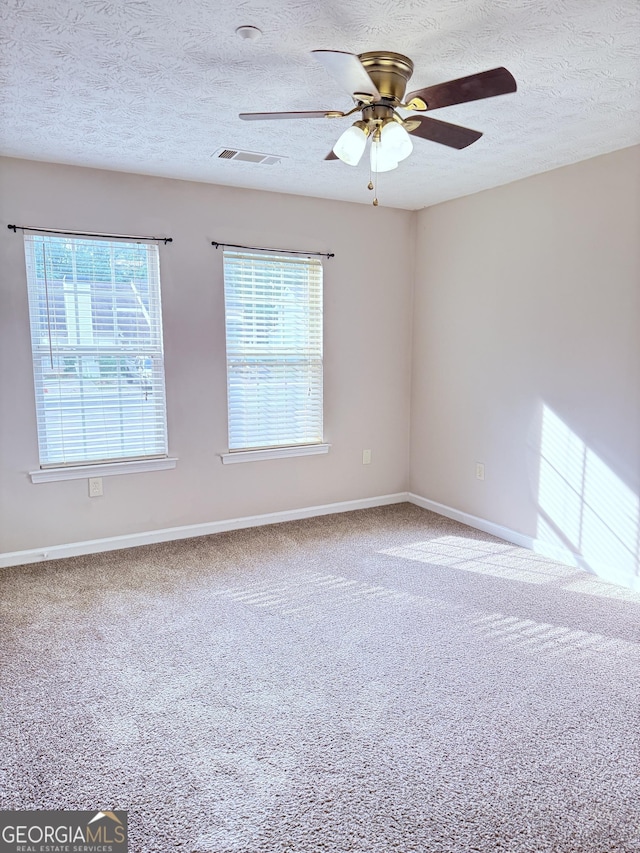 6433 Wellington Chase Ct, Lithonia, GA 30058 - carpeted spare room featuring baseboards, ceiling fan, a textured ceiling, and visible vents