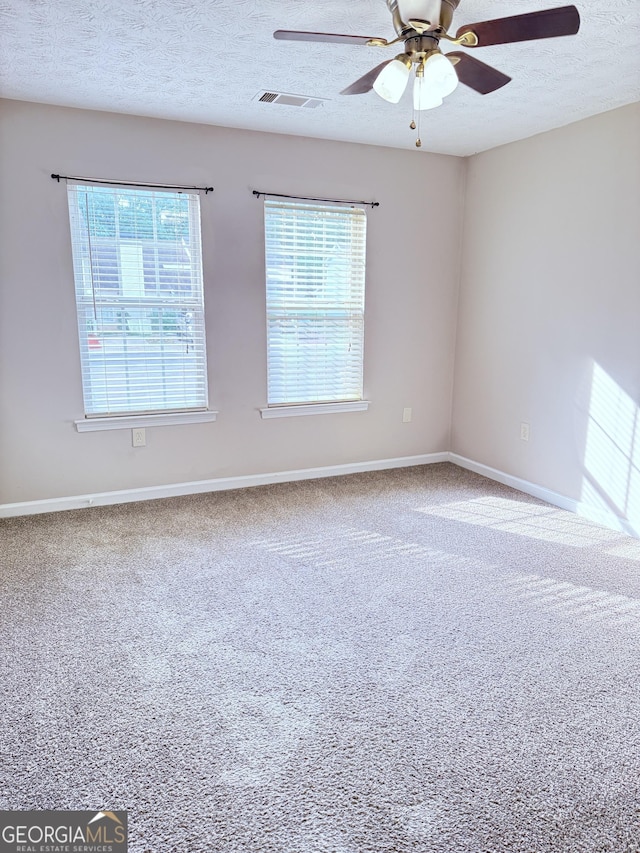 6433 Wellington Chase Ct, Lithonia, GA 30058 - unfurnished room featuring visible vents, carpet flooring, plenty of natural light, and a ceiling fan