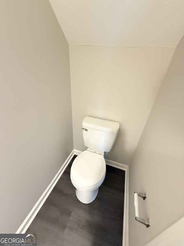 6433 Wellington Chase Ct, Lithonia, GA 30058 - bathroom featuring toilet, baseboards, wood finished floors, and lofted ceiling