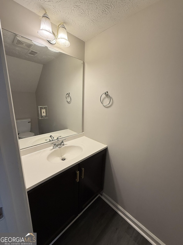 6433 Wellington Chase Ct, Lithonia, GA 30058 - bathroom with vanity, wood finished floors, visible vents, and toilet
