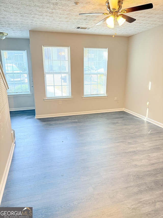 6433 Wellington Chase Ct, Lithonia, GA 30058 - unfurnished living room with baseboards, ceiling fan, a textured ceiling, and wood finished floors