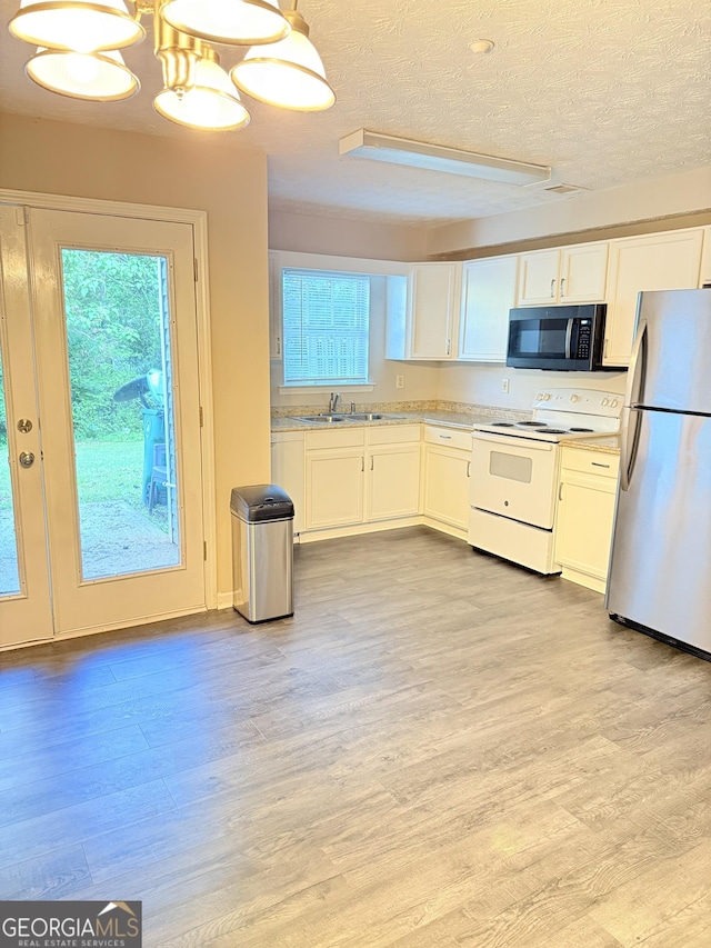 6433 Wellington Chase Ct, Lithonia, GA 30058 - kitchen with a sink, freestanding refrigerator, light wood-type flooring, and electric stove