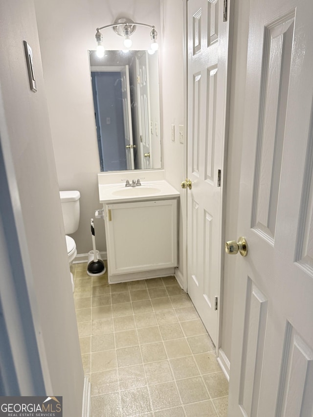 6433 Wellington Chase Ct, Lithonia, GA 30058 - half bath with baseboards, tile patterned flooring, vanity, and toilet
