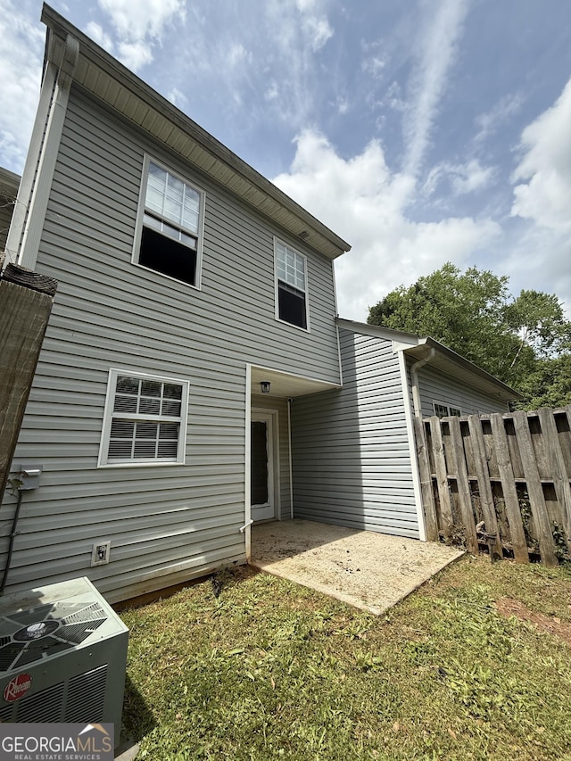 6433 Wellington Chase Ct, Lithonia, GA 30058 - rear view of house featuring a patio, central AC unit, and fence