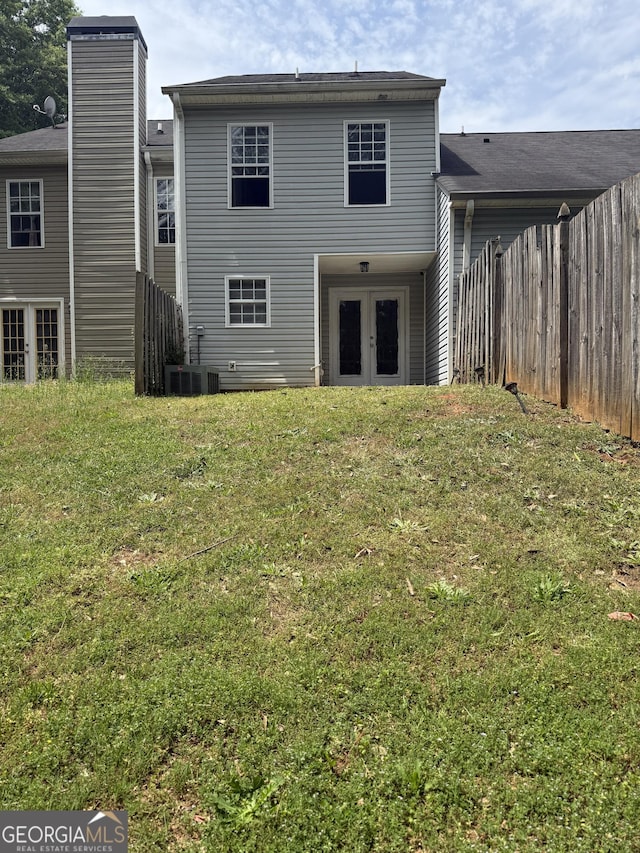 6433 Wellington Chase Ct, Lithonia, GA 30058 - back of house featuring fence, a yard, and french doors