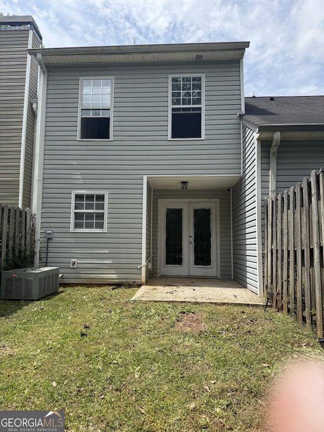 6433 Wellington Chase Ct, Lithonia, GA 30058 - rear view of house featuring a yard, fence, french doors, and central AC unit