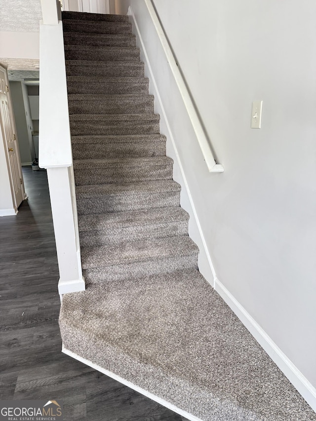 6433 Wellington Chase Ct, Lithonia, GA 30058 - stairway with baseboards and wood finished floors