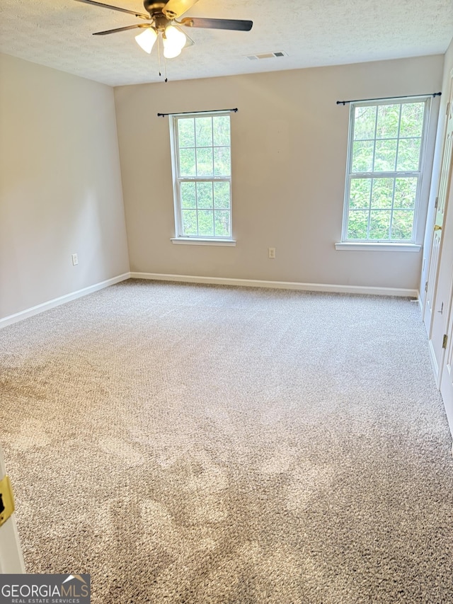 6433 Wellington Chase Ct, Lithonia, GA 30058 - empty room featuring visible vents, a ceiling fan, carpet floors, and a healthy amount of sunlight