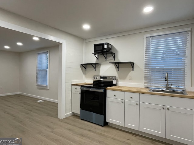 130 S Avenue SE, Marietta, GA 30060 - kitchen with stainless steel electric range oven, open shelves, a sink, light wood finished floors, and wooden counters