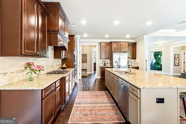 kitchen featuring backsplash, dark wood-style flooring, a sink, light stone counters, and stainless steel appliances