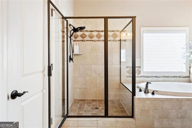 bathroom featuring a bath and a stall shower