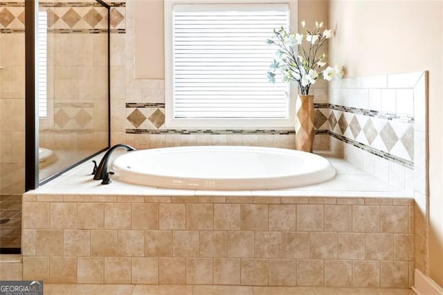 full bath with a bath and a wealth of natural light