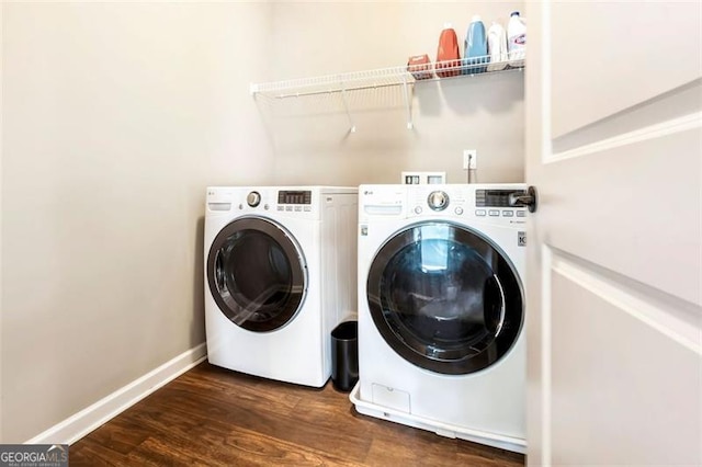 washroom featuring laundry area, baseboards, independent washer and dryer, and dark wood-style floors