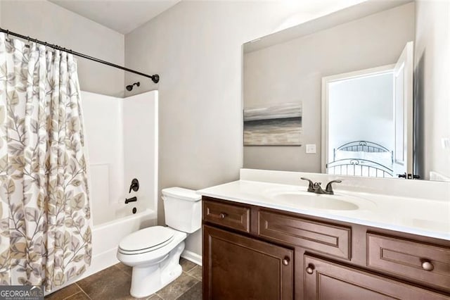 bathroom featuring vanity, tile patterned flooring, shower / bath combo, and toilet