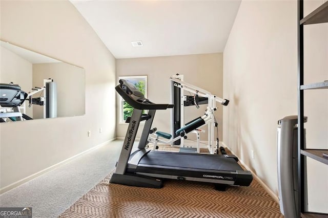 workout area with baseboards, carpet, vaulted ceiling, and visible vents