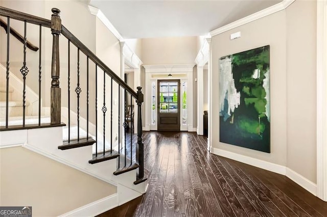 foyer featuring stairway, baseboards, and wood finished floors
