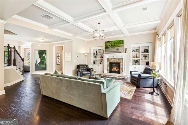 living room featuring dark wood-style flooring, a fireplace, stairs, visible vents, and coffered ceiling