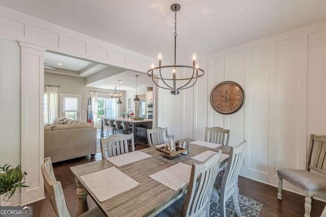 21 E Field St, Newnan, GA 30263 - dining room featuring an inviting chandelier, dark wood-style flooring, and a decorative wall