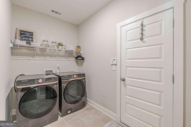 21 E Field St, Newnan, GA 30263 - laundry area with laundry area, baseboards, visible vents, and washing machine and clothes dryer