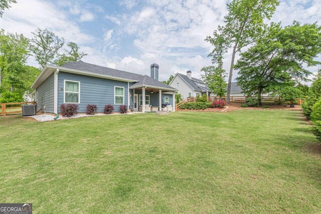 21 E Field St, Newnan, GA 30263 - back of house featuring a fenced backyard, central AC unit, and a lawn