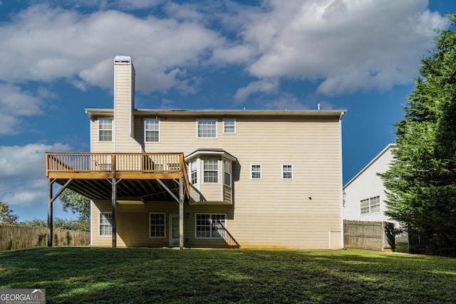 981 Charles Hall Dr, Dacula, GA 30019 - rear view of house with a yard, fence, a wooden deck, and a chimney
