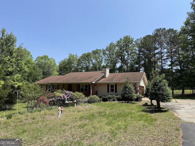 7260 Cox Rd, Cumming, GA 30028 - single story home with a chimney, driveway, and a front lawn