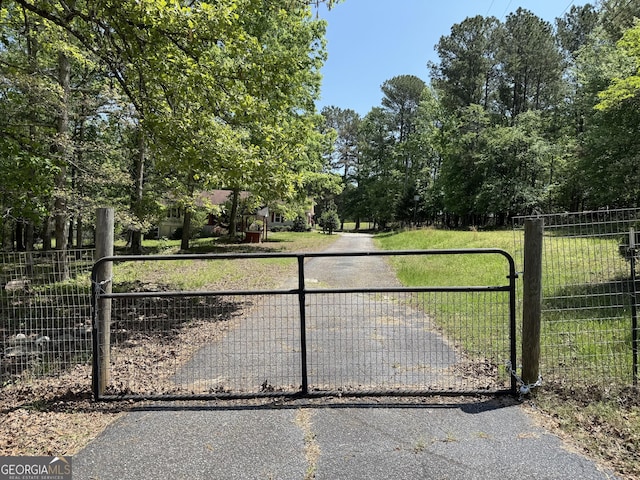 7260 Cox Rd, Cumming, GA 30028 - view of gate with a lawn and fence