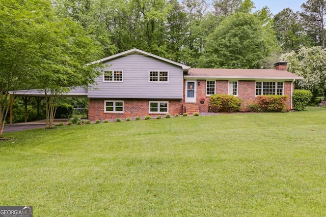 split level home with brick siding, a front lawn, a chimney, and a carport