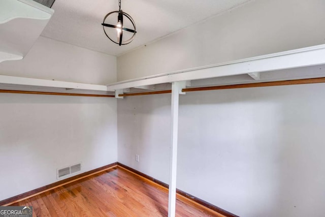 spacious closet with visible vents and wood finished floors