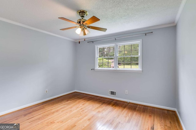 unfurnished room featuring visible vents, a ceiling fan, wood-type flooring, and baseboards