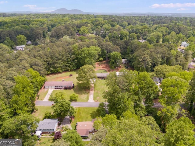 birds eye view of property with a wooded view