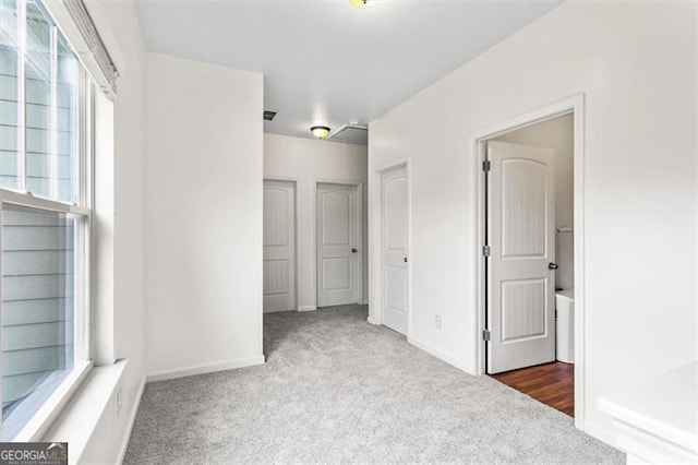 unfurnished bedroom featuring carpet flooring and baseboards
