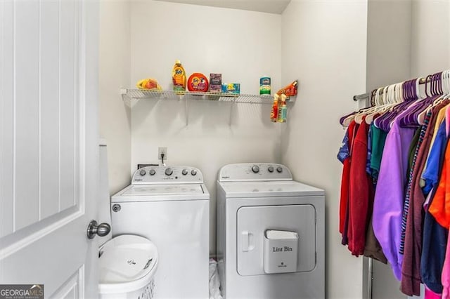 washroom with separate washer and dryer and laundry area