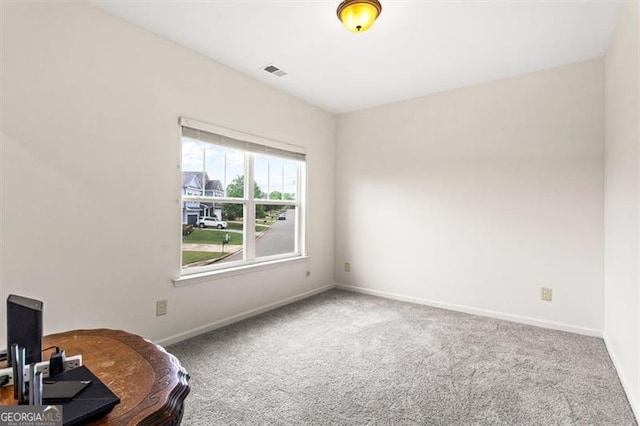 carpeted empty room with baseboards and visible vents