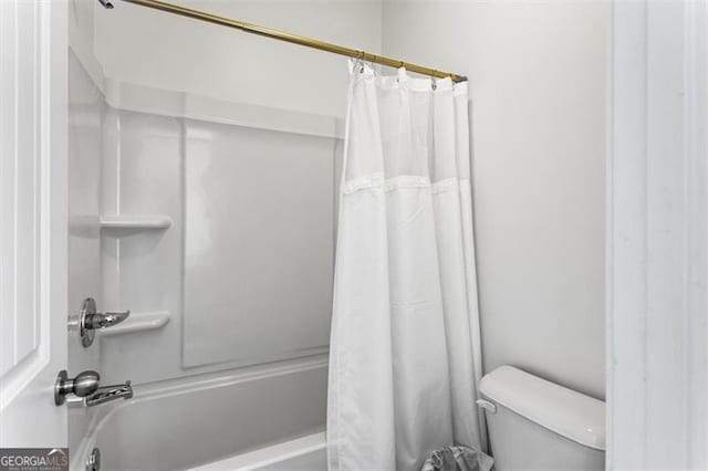 bathroom featuring shower / bathtub combination with curtain and toilet