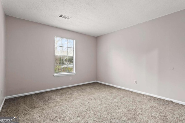 1056 Park W Ct, Stone Mountain, GA 30088 - spare room featuring carpet floors, a textured ceiling, baseboards, and visible vents