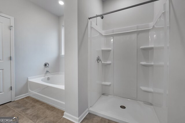 full bathroom featuring baseboards, walk in shower, tile patterned floors, and a bath