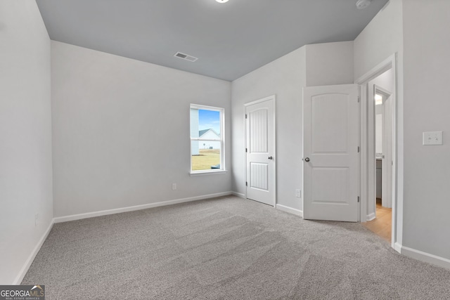 unfurnished bedroom with carpet floors, baseboards, a closet, and visible vents