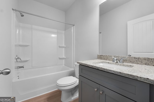 bathroom with toilet, shower / washtub combination, wood finished floors, and vanity