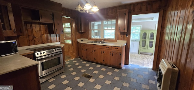 kitchen featuring a sink, light countertops, heating unit, and stainless steel range with electric cooktop