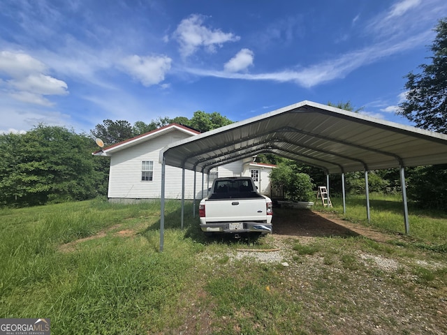 view of parking / parking lot with driveway and a detached carport