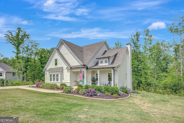 34 Oakleigh Trl, Newnan, GA 30265 - view of front of property with board and batten siding, a chimney, roof with shingles, and a front lawn