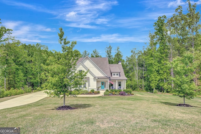 34 Oakleigh Trl, Newnan, GA 30265 - view of front of property with board and batten siding, a chimney, and a front yard