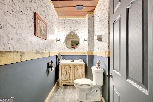 34 Oakleigh Trl, Newnan, GA 30265 - half bath with vanity, toilet, wallpapered walls, and wood finished floors