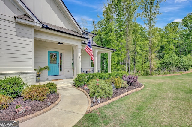 34 Oakleigh Trl, Newnan, GA 30265 - view of exterior entry with a lawn, covered porch, and board and batten siding