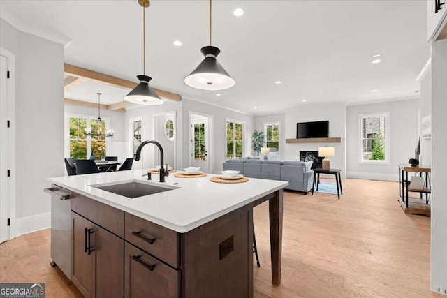 kitchen featuring a sink, light countertops, stainless steel dishwasher, and recessed lighting