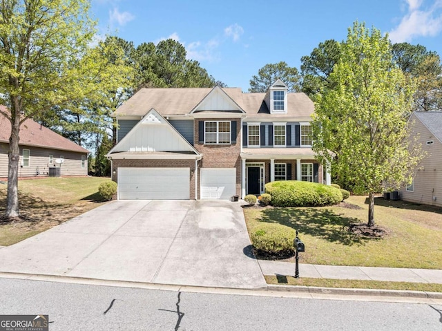 view of front of house featuring a front lawn, brick siding, a garage, central AC unit, and driveway