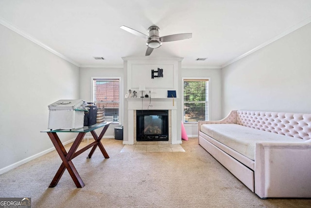 living room with crown molding, ceiling fan, visible vents, and light carpet