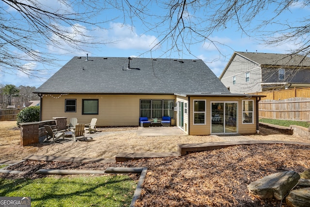 102 Wooded Glen Ln, Carrollton, GA 30117 - rear view of house featuring roof with shingles, fence, and a patio area